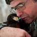 Master falconer Craig Perdue warms one of his raptors, Gloria, while hunting on February 14. Perdue also owns a Harris's Hawk, a Great Horned Owl, a European Starling and plans to acquire more birds. "I really am fascinated with how the birds think and understanding the mind," he says. "No better way to do that except by really participating with the bird, doing what it does, living with the bird." Daniel Brenner I AnnArbor.com